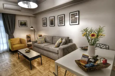 a living room with a couch and a table at Top Koukaki Location 3rd floor 2bdr in Athens
