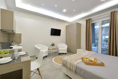 a room with a bed and a kitchen and a table at Alekos Apartments 2 Netflix, Self Check-In in Athens
