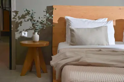 a bedroom with a bed and a table with a vase on it at Alekos Apartments 2 Netflix, Self Check-In in Athens
