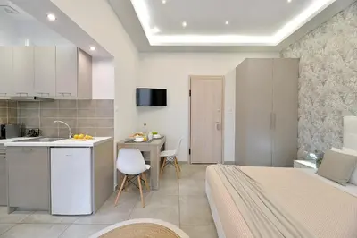 a kitchen and living room with a bed and a table at Alekos Apartments 2 Netflix, Self Check-In in Athens