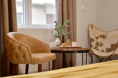 a room with a table and a chair and a table with at Alekos Apartments 2 Netflix, Self Check-In in Athens