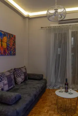 a living room with a couch and a table at Fix Divine Apartment in Athens