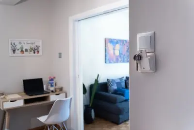 a room with a desk with a computer and a chair at Fix Divine Apartment in Athens