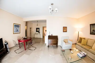a living room with a couch and a table at Flisvos Seafront-Marina apartment in Athens