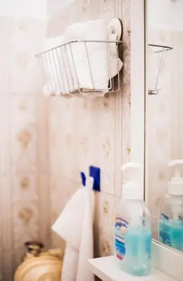 a bathroom with a towel rack and a mirror at Flisvos Seafront-Marina apartment in Athens