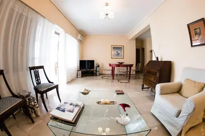 a living room with a couch and a table at Flisvos Seafront-Marina apartment in Athens