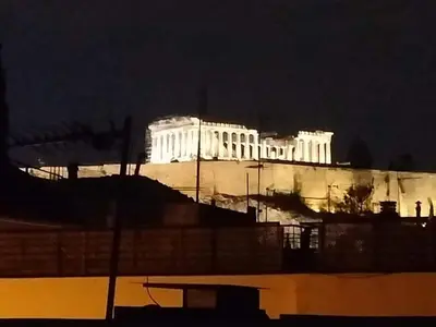 a lit up building in the city at night at Androniki suite in Athens