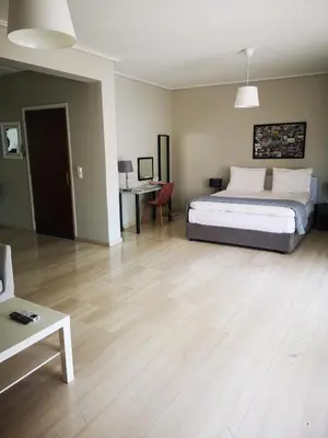 a large bedroom with a bed and a table at Androniki suite in Athens