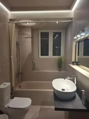 a bathroom with a sink and a toilet and a tub at Androniki suite in Athens
