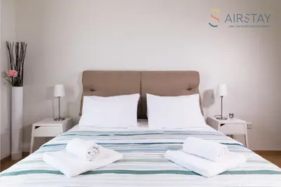 a bedroom with a bed with two white towels on it at Anivia Apartments Airport by Airstay in Spáta