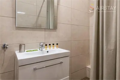 a bathroom with a sink and a mirror and a shower at Anivia Apartments Airport by Airstay in Spáta