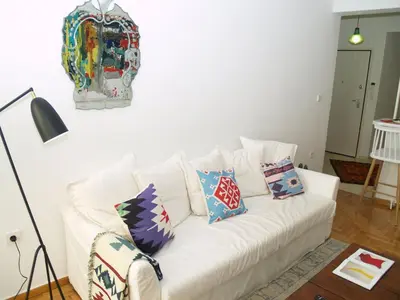 a white couch with pillows on it in a living room at A Refreshed & Rich in Details Apartment in Piraeus (Passalimani - Marina Zeas) in Piraeus