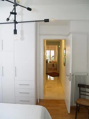 a bedroom with a white bed and a hallway at A Refreshed & Rich in Details Apartment in Piraeus (Passalimani - Marina Zeas) in Piraeus