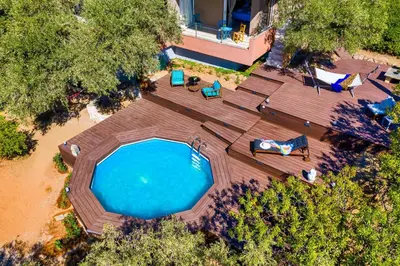 an overhead view of a swimming pool with a deck and chairs at Lagonisi Villa Afroditi in Lagonissi