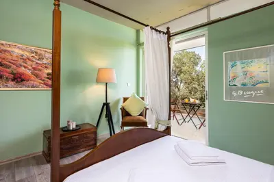 a bedroom with a bed and a window at Lagonisi Villa Afroditi in Lagonissi