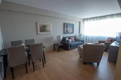 a living room with a couch and a table and chairs at Athens Center Panoramic Flats in Athens