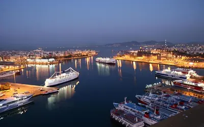 a group of boats docked in a harbor at night at Piraeus Premium Suites in Piraeus