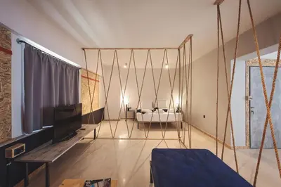 a living room with a bed and a swing at Piraeus Premium Suites in Piraeus