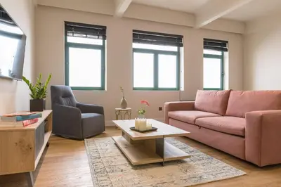 a living room with a couch and a table at Klepsydra Urban Suites in Athens