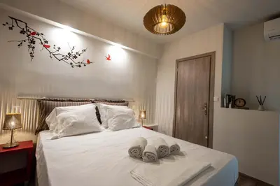 a bedroom with a bed with two towels on it at Acropolis Koukaki Newly Renovated 55sq.m Apartment in Athens