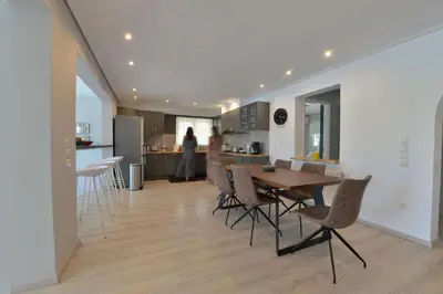 a dining room and kitchen with a table and chairs at Villa PortoMare in Porto Rafti