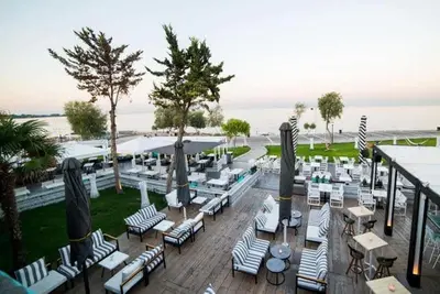 a view of a patio with chairs and tables at Family apt with garden next to the sea in Athens