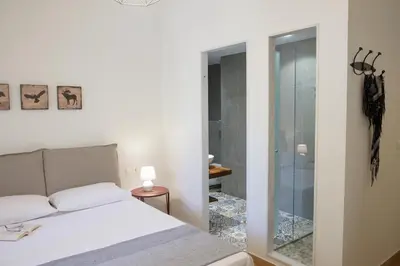 a bedroom with a bed and a glass shower at Luxury three bedroom Apartment in Kolonaki in Athens