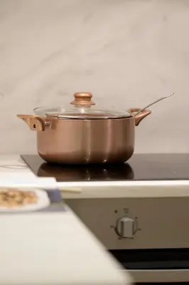 a copper pot sitting on top of a stove at Luxury three bedroom Apartment in Kolonaki in Athens