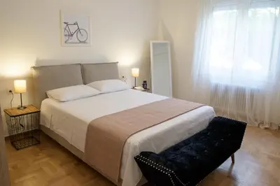 a bedroom with a large white bed and a window at Luxury three bedroom Apartment in Kolonaki in Athens
