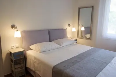 a bedroom with a large bed and a mirror at Luxury three bedroom Apartment in Kolonaki in Athens