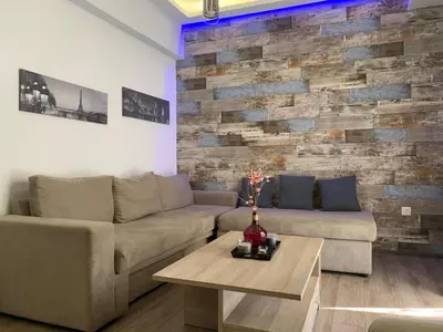 a living room with a couch and a table at Real Central New Flat - 1' to Metro - Direct Acropolis,Pireus - Best heating and cooling system in Athens