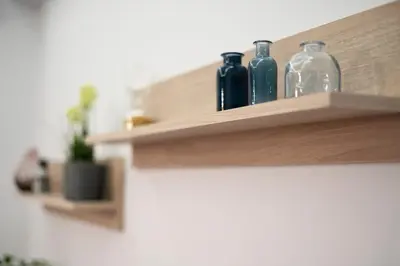 a wooden shelf with glass bottles on it at Real Central New Flat - 1' to Metro - Direct Acropolis,Pireus - Best heating and cooling system in Athens