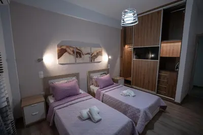 a room with two beds with towels on them at Real Central New Flat - 1' to Metro - Direct Acropolis,Pireus - Best heating and cooling system in Athens