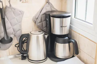 a coffee maker on a counter next to a window at Heart of the City in Athens