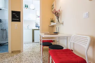 a small kitchen with a table and two chairs at Heart of the City in Athens