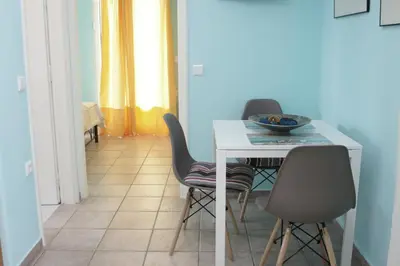 a dining room with a table and two chairs at Sunny Studio in Koropíon