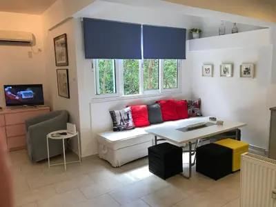 a living room with a couch and a table at Aris sweet home in Athens