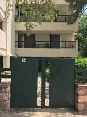 a green door in front of a building at Aris sweet home in Athens