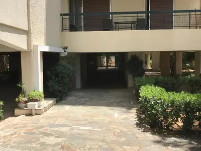 a building with a walkway leading to the front door at Aris sweet home in Athens