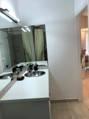 a white bathroom with two sinks and a mirror at Aris sweet home in Athens