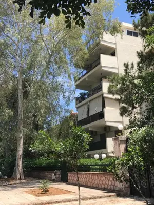 a white building with trees in front of it at Aris sweet home in Athens