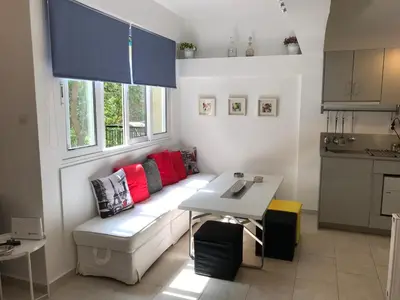 a living room with a couch and a table at Aris sweet home in Athens