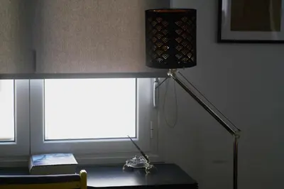 a lamp sitting on a desk next to a window at V&V Central & Elegant Apartment in Athens