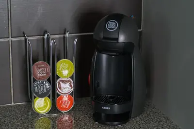 a black coffee maker sitting on a counter next to some buttons at V&V Central & Elegant Apartment in Athens