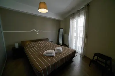 a bedroom with a bed with two towels on it at V&V Central & Elegant Apartment in Athens