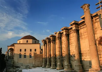 a building with columns and a building with a dome at Acropolis foothill in Athens