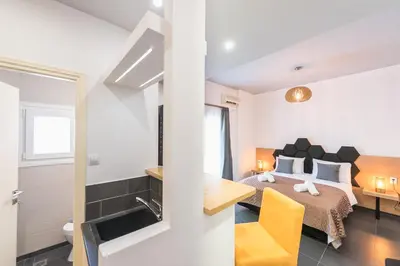 a bedroom with a bed and a bathroom at Acropolis foothill in Athens