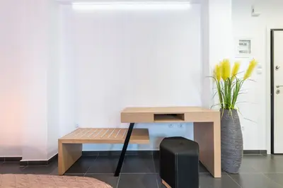 a desk and a suitcase in a room at Acropolis foothill in Athens