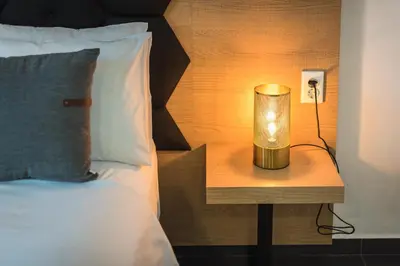 a lamp on a night stand next to a bed at Acropolis foothill in Athens