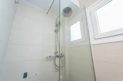 a shower with a glass door in a bathroom at Acropolis foothill in Athens